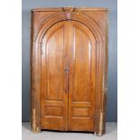A Late 18th Century Grained as Oak Tall Barrel Back Corner Cupboard, the pale painted interior