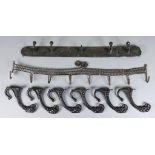 A Set of Six Cast Iron Coat Hooks, the upper terminals modelled as goat heads, 6ins high, a brass