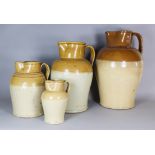 Four Two-Tone Glazed Stoneware Harvest Jugs, Late 19th Century, each with moulded rims and shoulders