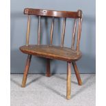An 18th/19th Century Primitive Low Windsor Stick Back Armchair, with traces of original red paint