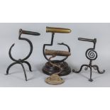 Four Goffering Irons, 19th Century, including wrought iron and brass on tripod base with curly toes,
