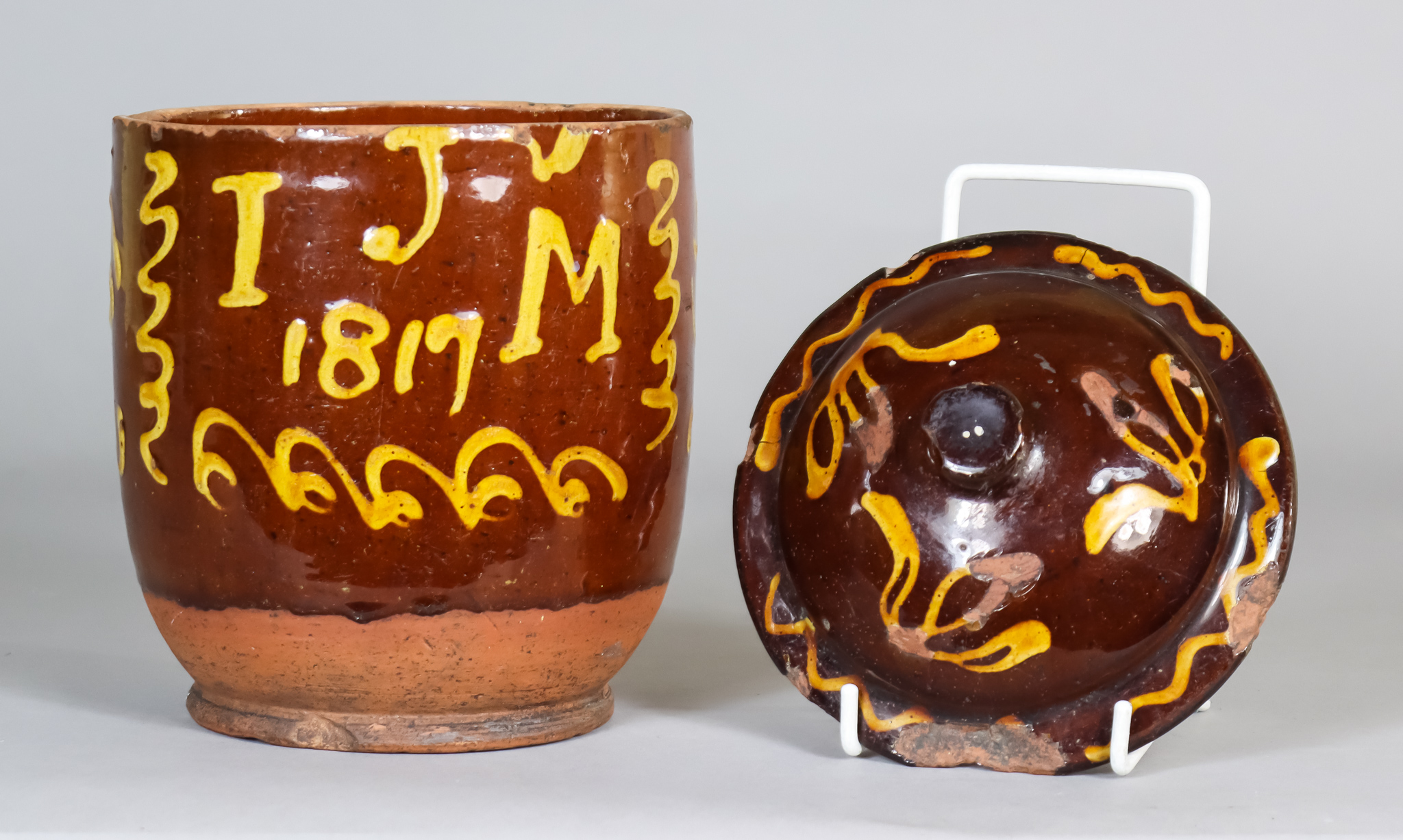 An English Dated Slip Ware Pot and a Cover, slip trailed with the initials "IJM" and dated 1817