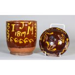 An English Dated Slip Ware Pot and a Cover, slip trailed with the initials "IJM" and dated 1817