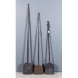 Three 19th Century Wrought Iron Bread Peels, with plain flat blades and various terminals, 62ins,