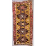 A Turkish Long Rug of Kazak Design, Modern, woven in muted colours with five bold cross motifs on
