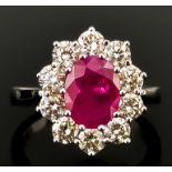 A Ruby and Diamond Ring, Modern, in 18ct white gold mount, set with a central faceted ruby,