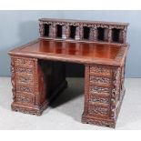 A Chinese Panelled Hardwood Rectangular Kneehole Desk, the whole bodly carved with exotic birds,