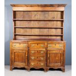 An Early 19th Century Fruitwood Breakfront Dresser Base, fitted three frieze drawers above three