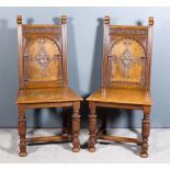 A Pair of Victorian Panelled Oak Hall Chairs of "17th Century" design, the back with scroll