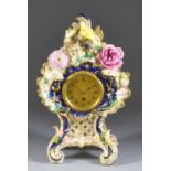 A Mid 19th Century English Porcelain Cased Mantel Timepiece, the 2.5ins diameter gilt dial with