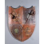 A Large German Decorative Shield, constructed from wooden planks embellished with metal motifs,