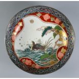 A Japanese Imari Porcelain Bowl, Circa 1900, the interior painted with a bird riding on the crest of