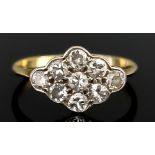 A Diamond Cluster Ring, 20th Century, in gold coloured metal mount, set with nine small brilliant