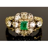 An Emerald and Diamond Oval Cluster Ring, Victorian, in gold coloured metal mount, set with a