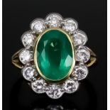 An Emerald and Diamond Ring, Modern, in 18ct gold mount, set with a central faceted emerald,