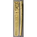 A Chinese Cantonese Ivory Page Turner, the blade finely carved with flowers on a textured ground,