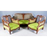 A 1920s Walnut Framed Three-Piece Bergere Lounge Suite, with shaped back with carved central motif