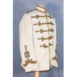 A Hussars Colonial Tunic, brass buttons with crown motif, trimmed with gold cord work