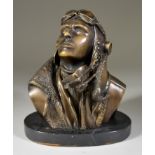 A 20th Century Bronze Bust of a Fighter Pilot, signed R S, on black marble base, 8 ins x 6ins