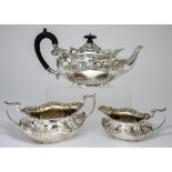 An Edward VII Silver and Silver Gilt Oval Three-Piece Tea Service, by Joseph Rodgers & Sons,