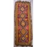 A Near Eastern Khelim, woven in colours, five bold hooked and lozenge shaped medallions on a wine