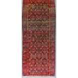 A Malayer Runner, Late 19th/Early 20th Century, woven in colours, with endless stylised floral