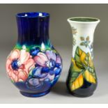 A Moorcroft Pottery Bulbous Vase, Early 20th Century, tube lined with flowers on a blue ground, 9ins