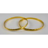 Two Gold Colour Metal Stiff Bangles, Modern, gross weight 26.4g Note: Metal unmarked but tests as