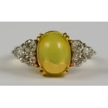 An Opal and Diamond Ring, Modern, in 18ct yellow gold mount, set with centre cabochon opal