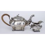 A George V Silver Oval Teapot and a Victorian Silver Milk Jug, the teapot makers mark rubbed,