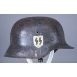 A German World War II Helmet, painted, with faint double decals