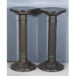 A Pair of Simulated Marble Composition Circular Pedestals, with plain tops on fluted columns and