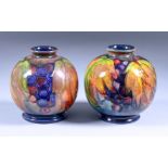 A Matched Pair of Moorcroft Pottery Squat Vases, Circa 1928-1934, decorated with a leaf and fruit