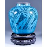 A Persian Turquoise Pottery Jar, painted in black with fish amongst reeds, with pewter rim, 9.