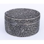 A Chinese Silvery Metal Circular Box and Cover, pierced and embossed with flowering branches, prunus