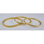 Three Gold Colour Metal Stiff Bangles, Modern, gross weight 22.1g Note: Metal unmarked but tests