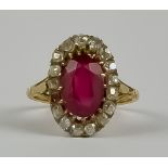 A Ruby and Diamond Ring, Early 20th Century, in gold colour metal mount, set with central faceted