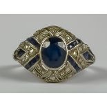 A Sapphire and Diamond Ring, Early 20th Century, in 14ct white gold mount, set with a central