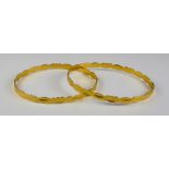 Two Gold Colour Metal Stiff Bangles, Modern, gross weight 21.8g Note: Metal unmarked but tests as