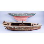 An Early 20th Century Tin Plate Model of a Freighter, 25ins overall, and a wooden pond yacht hull,