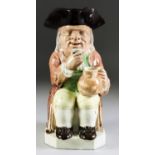 A Rare Wood Family Toby Jug of "Mould 51" Type, circa 1790, the figure seated and holding a raised