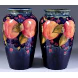 Two Moorcroft Pottery Baluster Shaped Vases, decorated with muted colours with "Pomegranate"