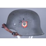 A German World War II Helmet, painted, with double decals, SS runes and swastika on shield