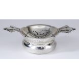 An Edward VIII Silver Commemorative Two-Handled Tea Strainer and Stand, by R.E. Stone, London