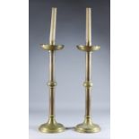 A Pair of Ecclesiastical Brass Candlesticks, Late 19th Century, with wide drip pans over a plain