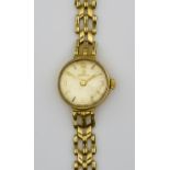 A Lady's Omega Manual Wind Wristwatch, 9ct Gold Cased, the champagne dial with Arabic baton numerals