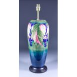 A Moorcroft Pottery Table Lamp with "Grape and Leaf" design, on turned wooden base, 20.5ins high