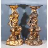 A Pair of Late 19th/Early 20th Century Gilt Papier Mache Stands, with circular ebonised tops, each