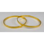 Two Gold Colour Metal Stiff Bangles, Modern, gross weight 27.5g Note: Metal unmarked but tests as