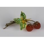 A Gold Coloured Metal Brooch Modelled in the Form of Two Strawberries, and a leaf set with small